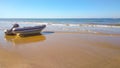 Rubber inflatable boat on the sandy seashore on a sunny day Royalty Free Stock Photo