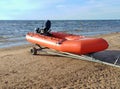 Rubber lifeboat in orange by the sea Royalty Free Stock Photo