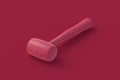Rubber mallet of magenta on red background