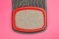 Rubber mat and cat litter tray with filler on pink background, top view