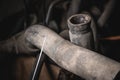 Rubber pipes and hoses leading from the car radiator to the engine, view of the engine from below. old worn rubber car