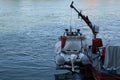 Rubber rescue boat hangs behind a fire brigade fire boat in Basel Royalty Free Stock Photo