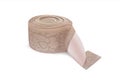 Rubber roll with gel tape. Beige elastic band roll for sewing close-up.Fabric tape for needlework of the cloth on white background