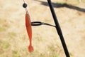 Rubber silicone orange fishing bait with hook and fishing line with rod outdoors