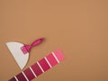 Rubber spatula and the palette of pink flowers. Beige background.