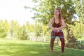 Rubber squat. Fitness. Athlete girl, thlete exercise at outside, woman fitness. Young Beautiful Woman Stretching Royalty Free Stock Photo