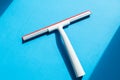 Rubber squeegee for cleaning window on the blue background