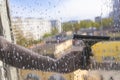 Rubber squeegee in male hand cleans a soaped window