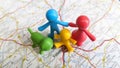 A rubber toy family standing together on Valladolid on a map of Spain