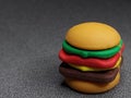 Rubber toy in the shape of a burger on a gray background
