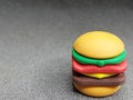 Rubber toy in the shape of a burger on a gray background