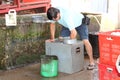 Rubber workers cleaning the rubber Container