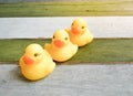 Rubber yellow ducks toy on wooden table background Royalty Free Stock Photo