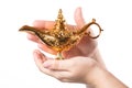 Rubbing magic lamp with female hands isolated on white background. Concept for wishing, luck and magic.