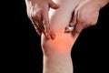 Rubbing medicated ointment into the affected knee Royalty Free Stock Photo