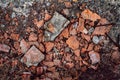 Rubbish from broken red bricks, broken building material, destruction from atmosphere, outdoors. Close-up grunge background Royalty Free Stock Photo