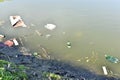 Rubbish, waste floating in polluted pond