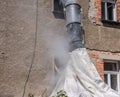 Rubble chute on a construction site with dirt