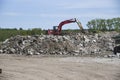 A rubble dump with an excavator cleaning up the mess