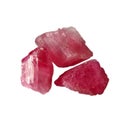 Three crude pink tourmaline rubellite stones on white background closeup