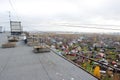 Ruberoid roof covering and railing on a multi-storey town house in Arkhangelsk.