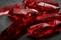 Rubies and raw crystal gems concept with closeup of a bunch of red rough uncut ruby crystals