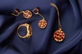 Rubies ring, necklace and earrings on blue silk background with