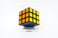 Rubik cube successful orange yellow blue with stand