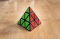 Madrid, Spain; 8 february 2019: Rubik pyramidal cube solved in a wood table Royalty Free Stock Photo