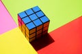 Rubik`s cube by blue side on a sunny colorful table