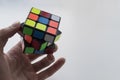 Rubik`s cube in man hand on white background. Close up photo Royalty Free Stock Photo