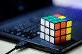 Rubik`s cube on laptop. techincal and business solving problem Royalty Free Stock Photo