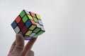 Rubik`s cube in child hand on white background. Close up photo