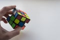 Rubik`s cube in man hand on white background. Close up photo Royalty Free Stock Photo