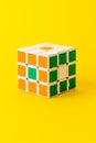 3x3 Rubik's cube isolated on yellow background. 3 by 3 Logic puzzle with box pattern.