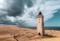 Rubjerg Knude Lighthouse on the coast of the North Sea in the Jutland in northern Denmark. Natural landscape with sand