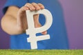 Ruble symbol in hands on a purple background. The concept of the growth or fall of the value of the ruble in the economy