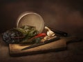 Ruby aka Swiss chard vegetable food preparation, still life with garlic. Chiaroscuro style light painting. Beta vulgaris