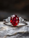 A ruby and diamond ring sitting on top of a rock Royalty Free Stock Photo