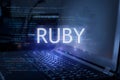 Ruby inscription against laptop and code background. Learn ruby programming language, computer courses, training Royalty Free Stock Photo