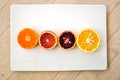 Ruby red blood oranges, navel oranges, and clementines cut in half Royalty Free Stock Photo