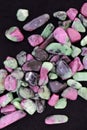 Ruby zoisite stones heap up texture on black background Royalty Free Stock Photo