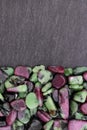 Ruby zoisite stones heap up texture on half black stone background Royalty Free Stock Photo