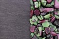 Ruby zoisite stones heap up texture on half black stone background Royalty Free Stock Photo