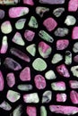 Ruby zoisite rare stones texture on black surface background Royalty Free Stock Photo