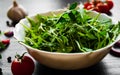 Rucola fresh salad in white bowl on dark wooden background Royalty Free Stock Photo