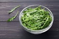 Rucola, salad rocket, rucoli, rugula, colewort, roquette or arugula on rustic table