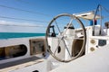 Rudder on a white catamaran ship with no sailor steering it Royalty Free Stock Photo