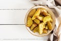 Ruddy Baked potato wedges with garlic on a white background Royalty Free Stock Photo