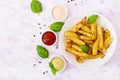 Ruddy Baked potato wedges with herbs Royalty Free Stock Photo